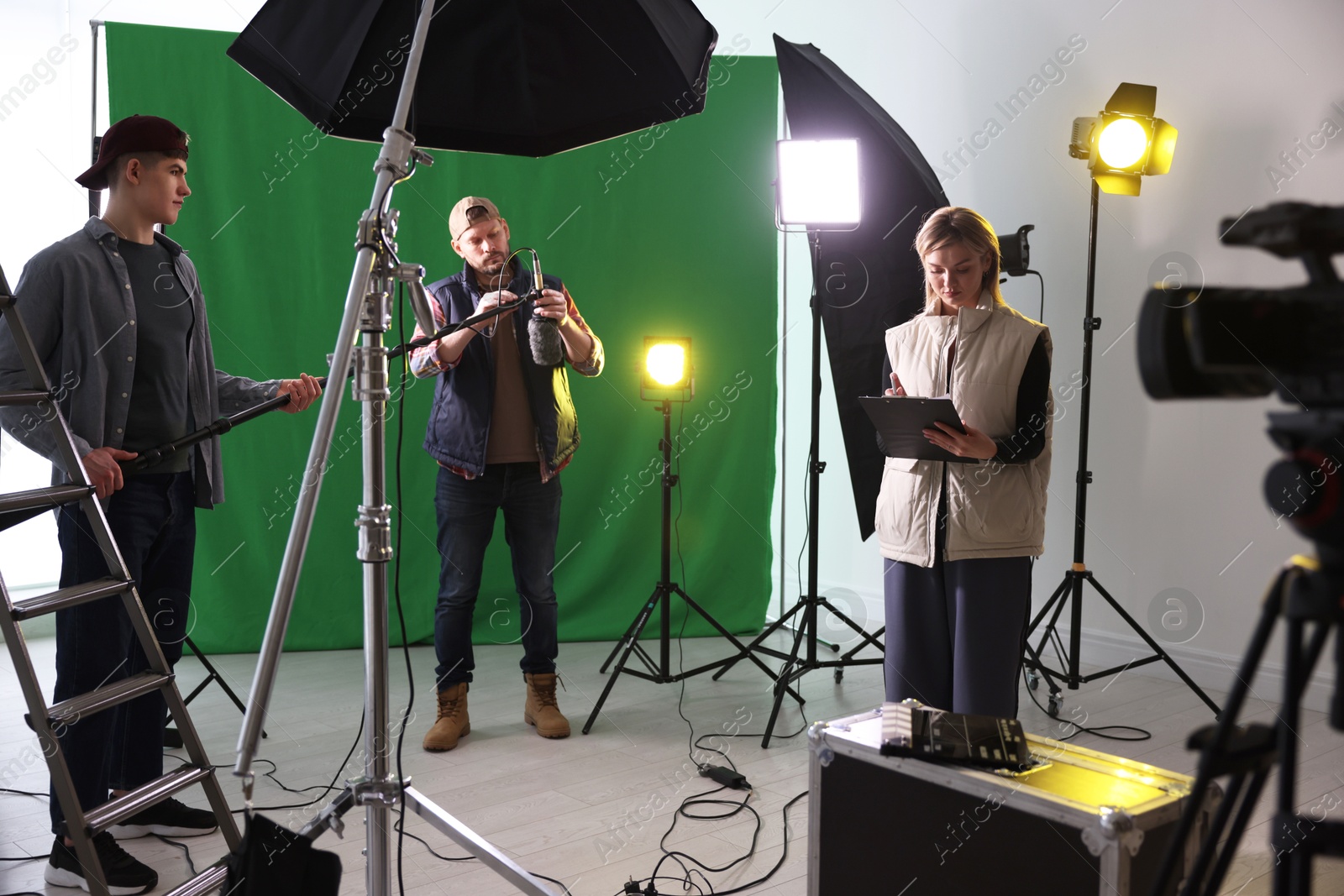 Photo of Group of people working in modern film studio