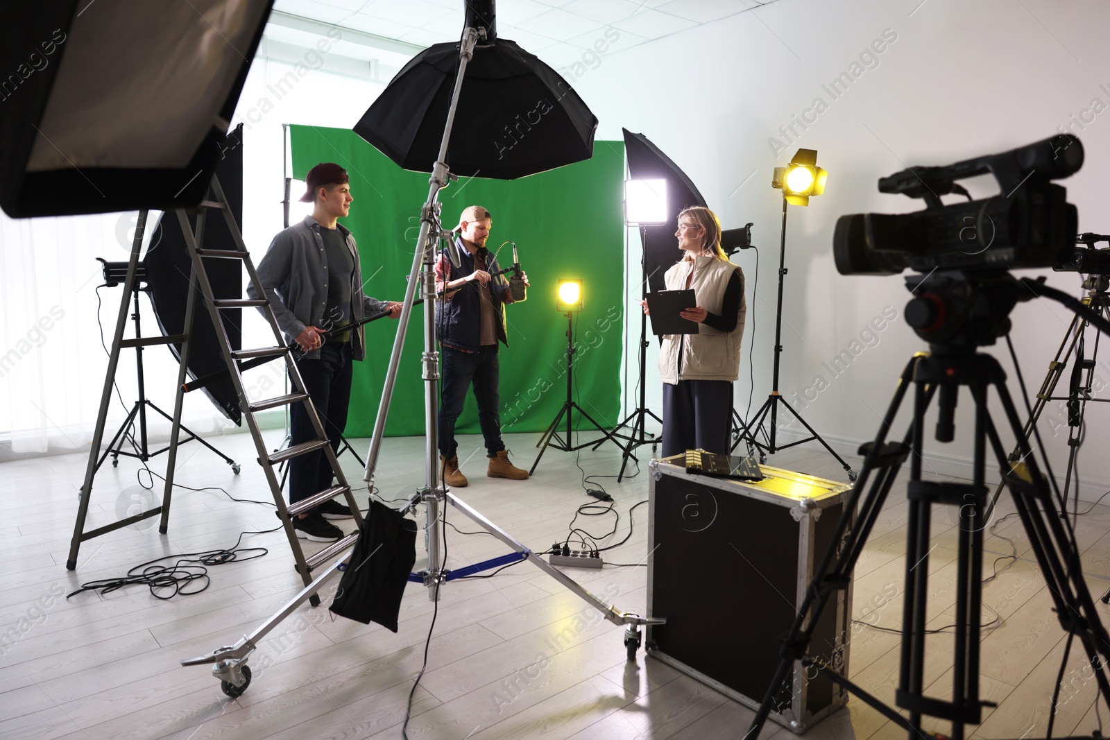 Photo of Group of people working in modern film studio