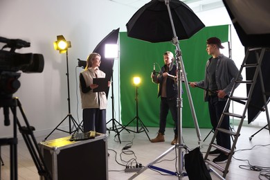 Photo of Group of people working in modern film studio