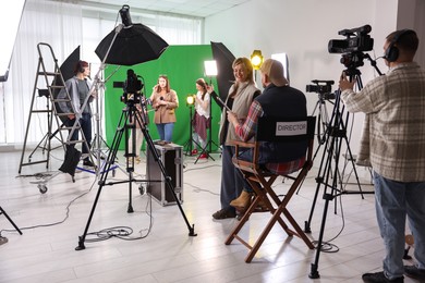 Group of people working in modern film studio