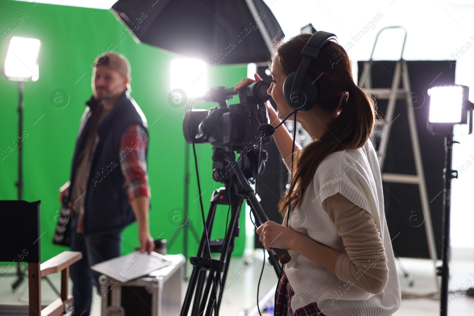 Photo of Man and woman working in modern film studio, selective focus