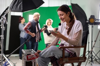 Photo of Group of people working in modern film studio