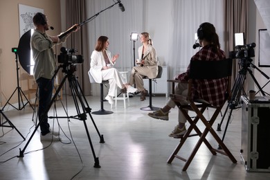 Photo of Group of people working in modern film studio