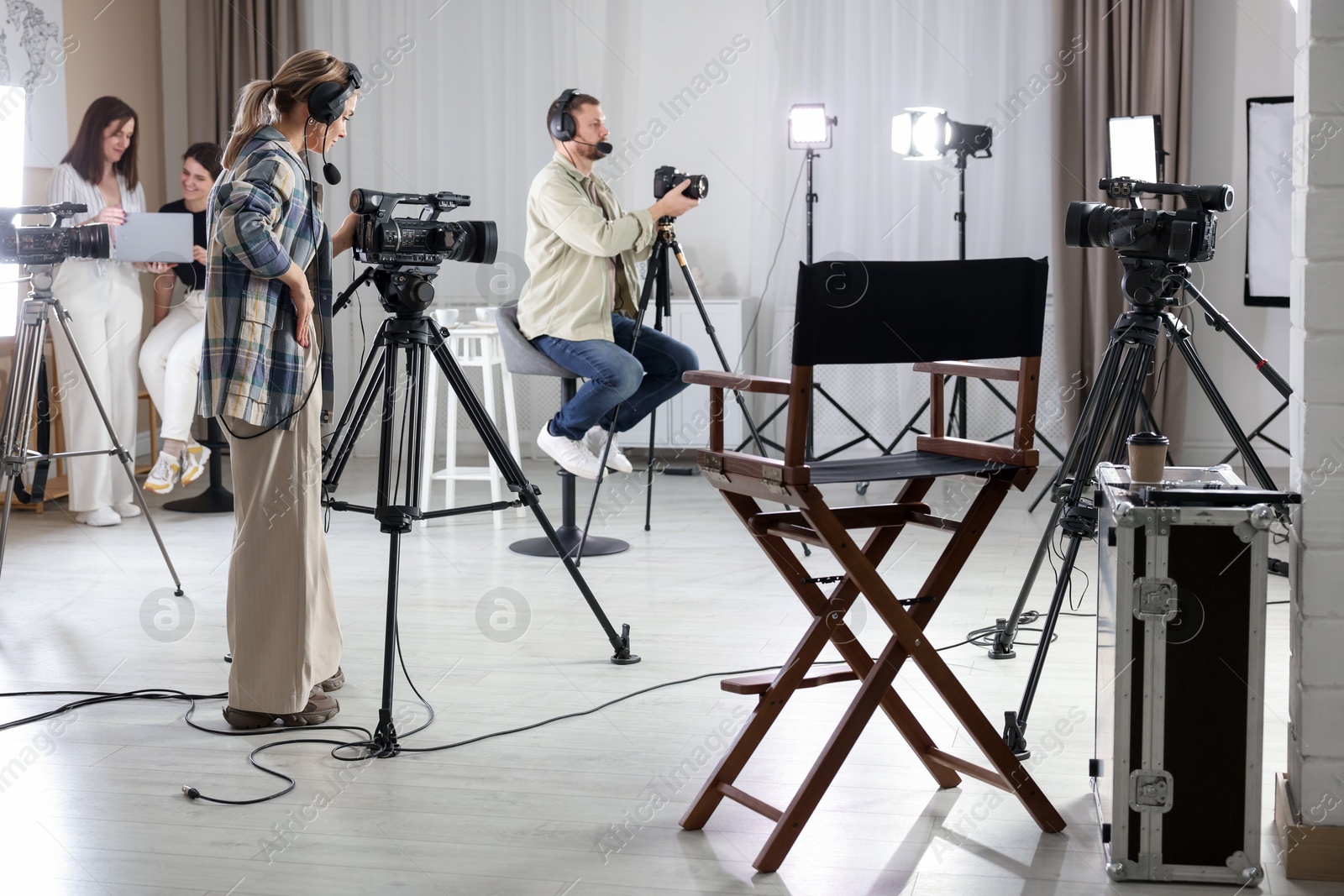 Photo of Group of people working in modern film studio