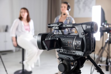 Photo of People working in film studio, focus on camera