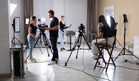 Group of people working in modern professional film studio