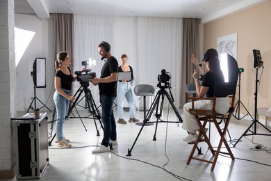 Photo of Group of people working in modern professional film studio