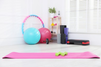 Photo of Many different fitness equipment and accessories indoors