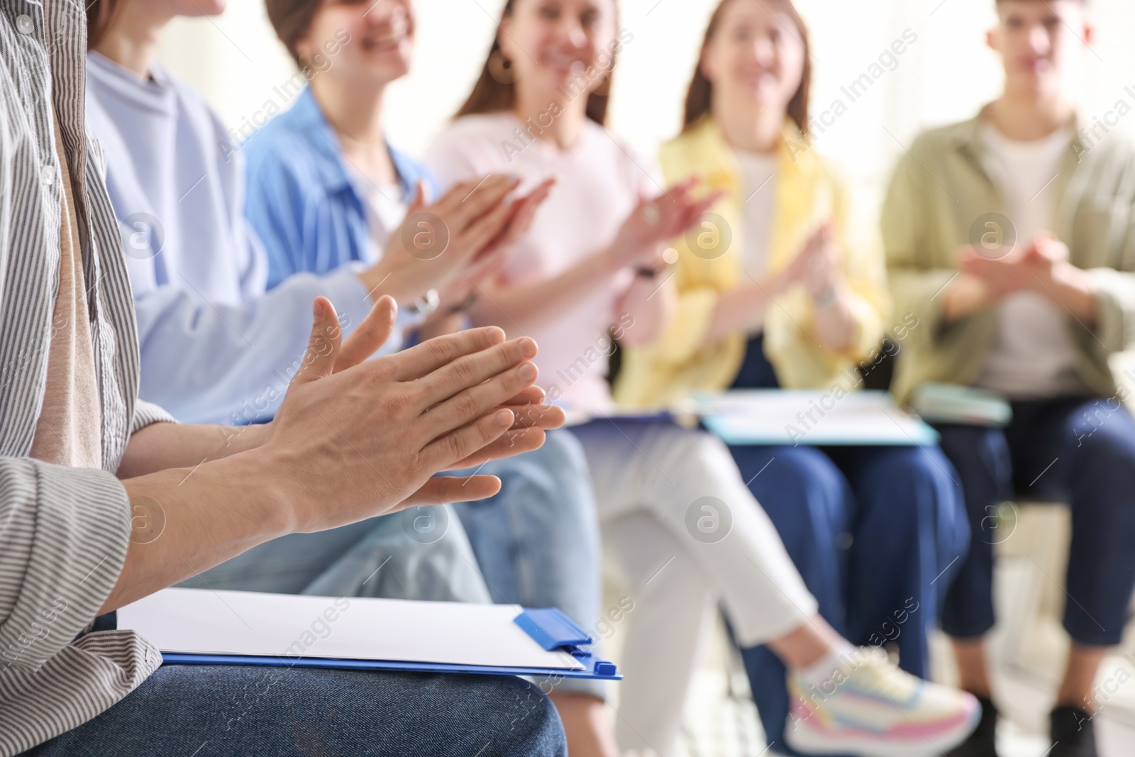 Photo of People applauding during meeting indoors, closeup view