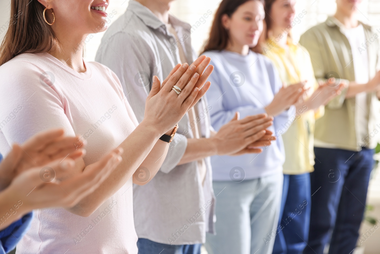 Photo of People applauding during meeting indoors, closeup view