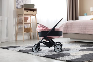 Photo of Doll stroller in children's room. Kid's toy