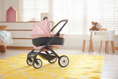 Photo of Doll stroller in children's room. Kid's toy