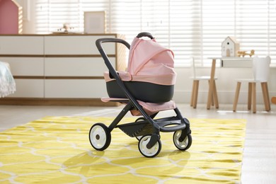 Photo of Doll stroller in children's room. Kid's toy