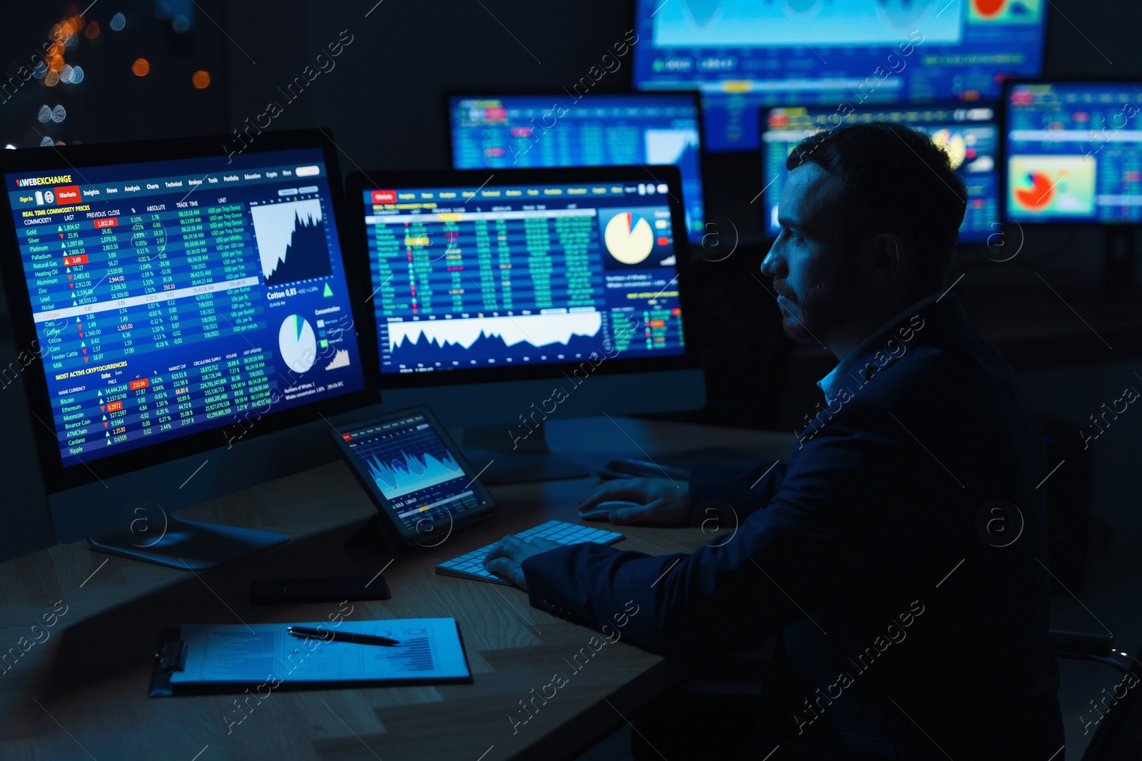 Photo of Financial trading specialist working in office at night