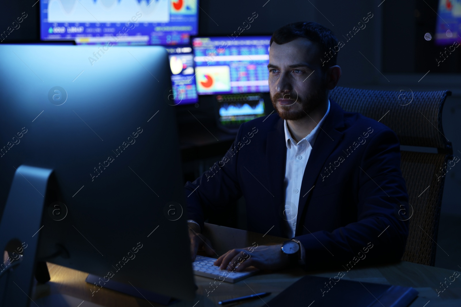 Photo of Financial trading specialist working in office at night