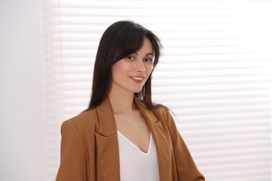 Photo of Portrait of beautiful businesswoman in stylish suit indoors