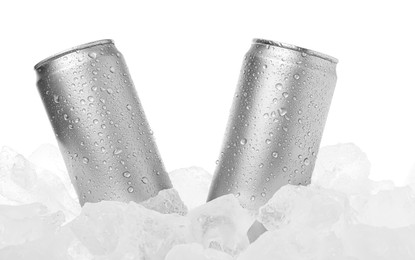 Photo of Refreshing drinks in cans on ice cubes against white background