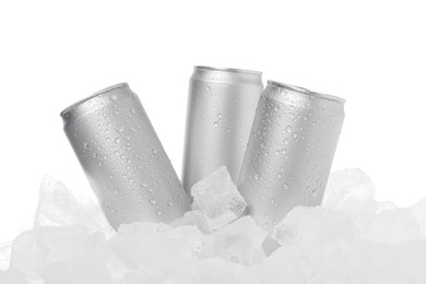 Photo of Refreshing drinks in cans on ice cubes against white background