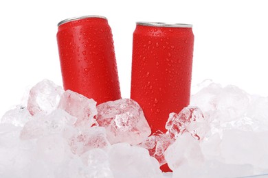 Photo of Refreshing drinks in cans on ice cubes against white background