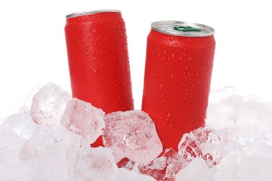 Photo of Refreshing drinks in cans on ice cubes against white background