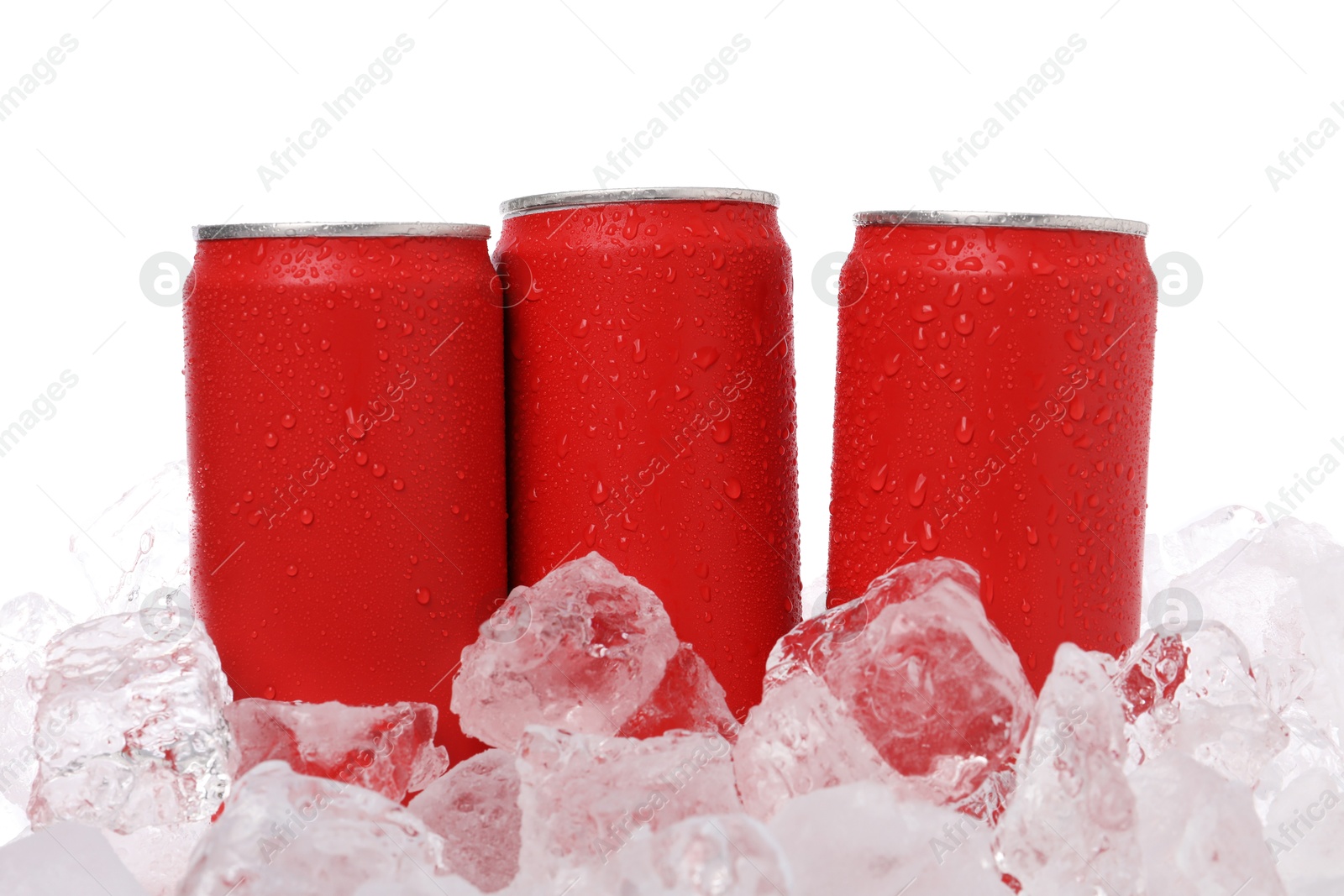 Refreshing drinks in cans on ice cubes against white background Photo of Refreshing drinks in cans on ice cubes against white background
