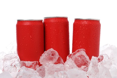Photo of Refreshing drinks in cans on ice cubes against white background