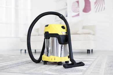 Photo of Modern hoover at home. Professional cleaning appliance