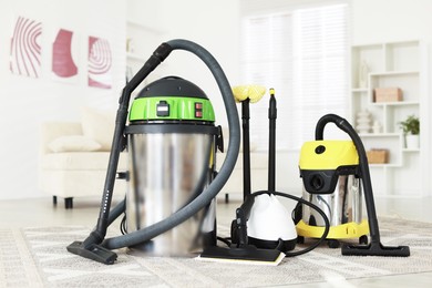 Photo of Professional hoovers and vapor steam system at home. Cleaning appliances