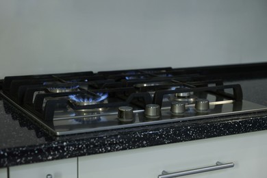 Photo of Stove with burners on counter in kitchen