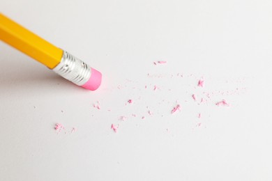Photo of Using pencil with eraser on white sheet of paper, above view