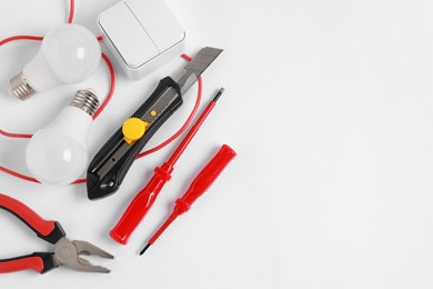 Photo of Different electrical tools on light background, flat lay. Space for text