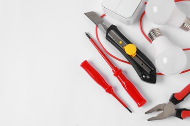 Photo of Different electrical tools on light background, flat lay. Space for text