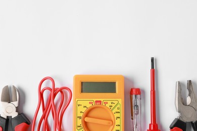 Photo of Different electrical tools on light background, flat lay. Space for text