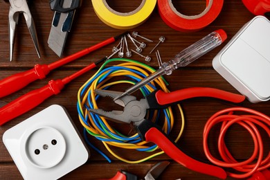 Photo of Different electrical tools on wooden table, flat lay