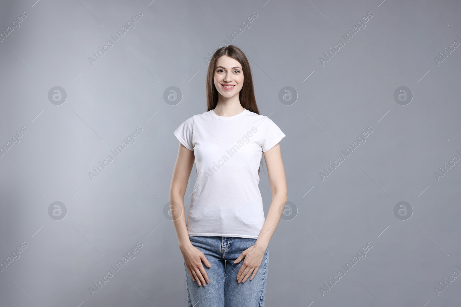 Photo of Woman wearing blank white t-shirt on light grey background. Mockup for design