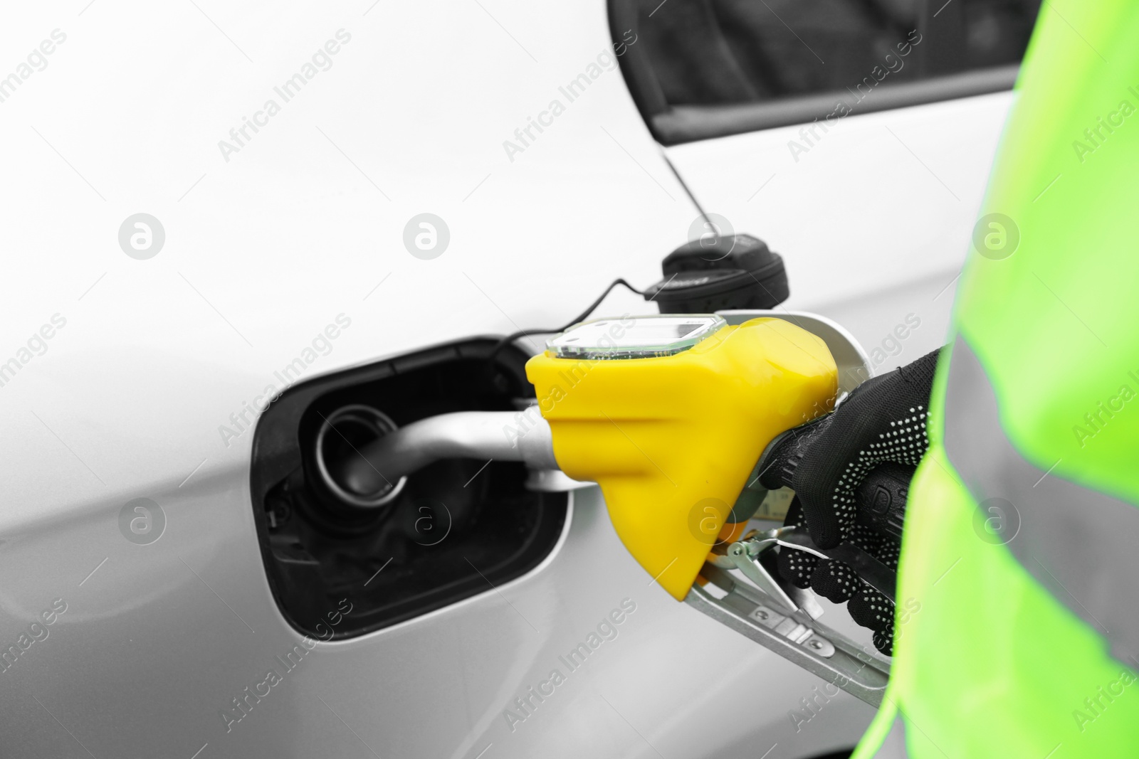 Photo of Man refueling his car at gas station, closeup