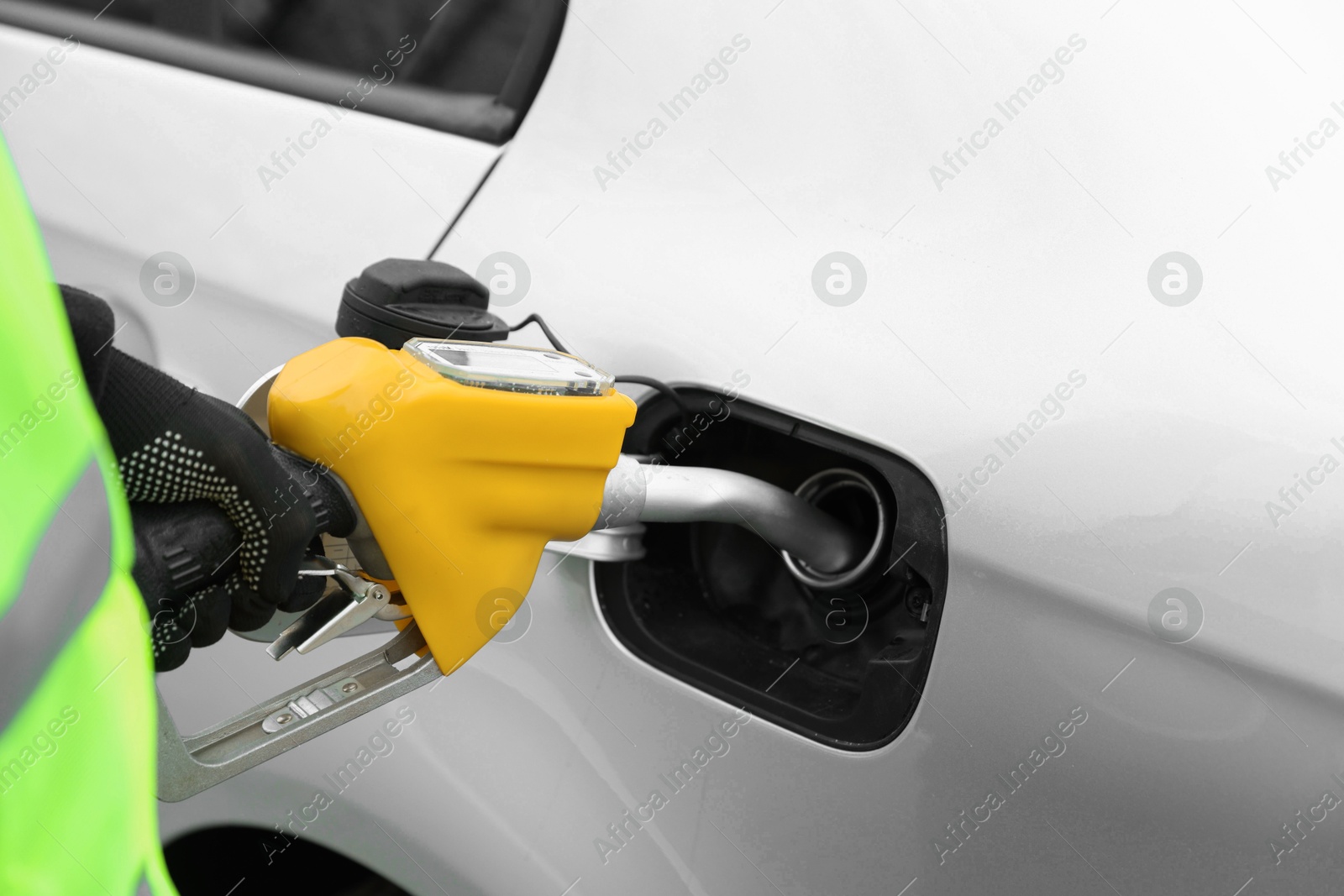 Photo of Man refueling his car at gas station, closeup