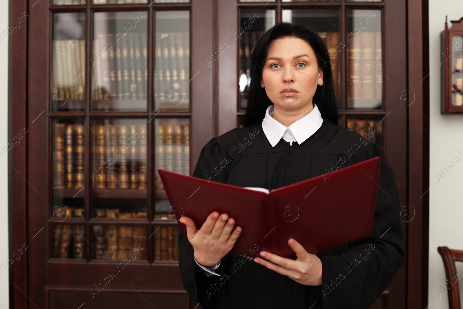 Photo of Judge with folder of documents in office, space for text