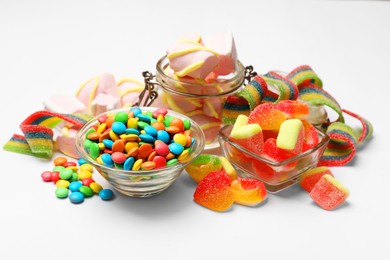 Photo of Many different tasty candies and marshmallows on white background, closeup