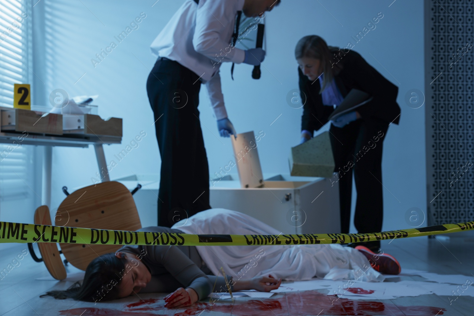 Photo of Forensic experts working at crime scene with dead woman's body indoors, selective focus