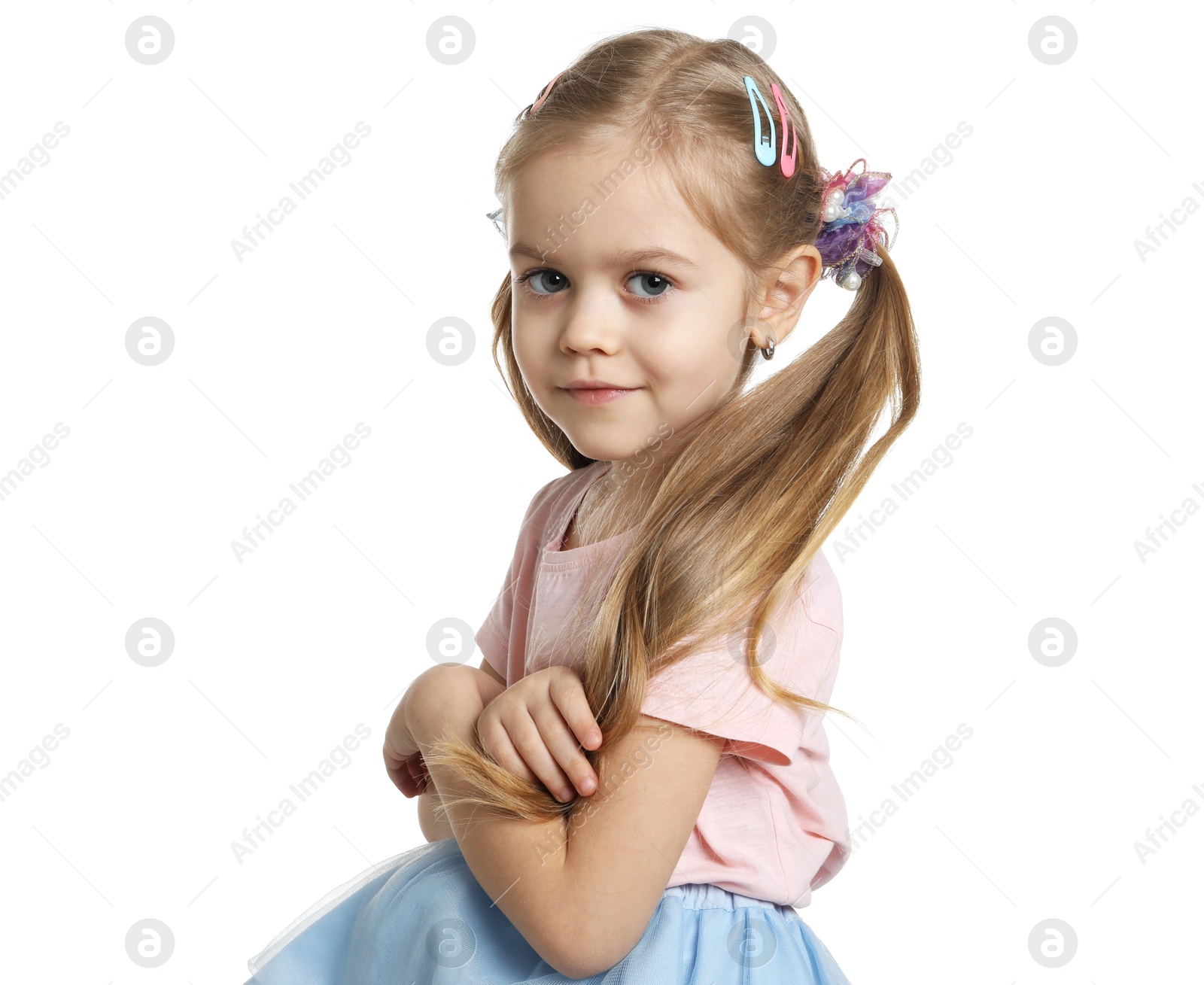 Photo of Cute little girl wearing beautiful hair accessories on white background