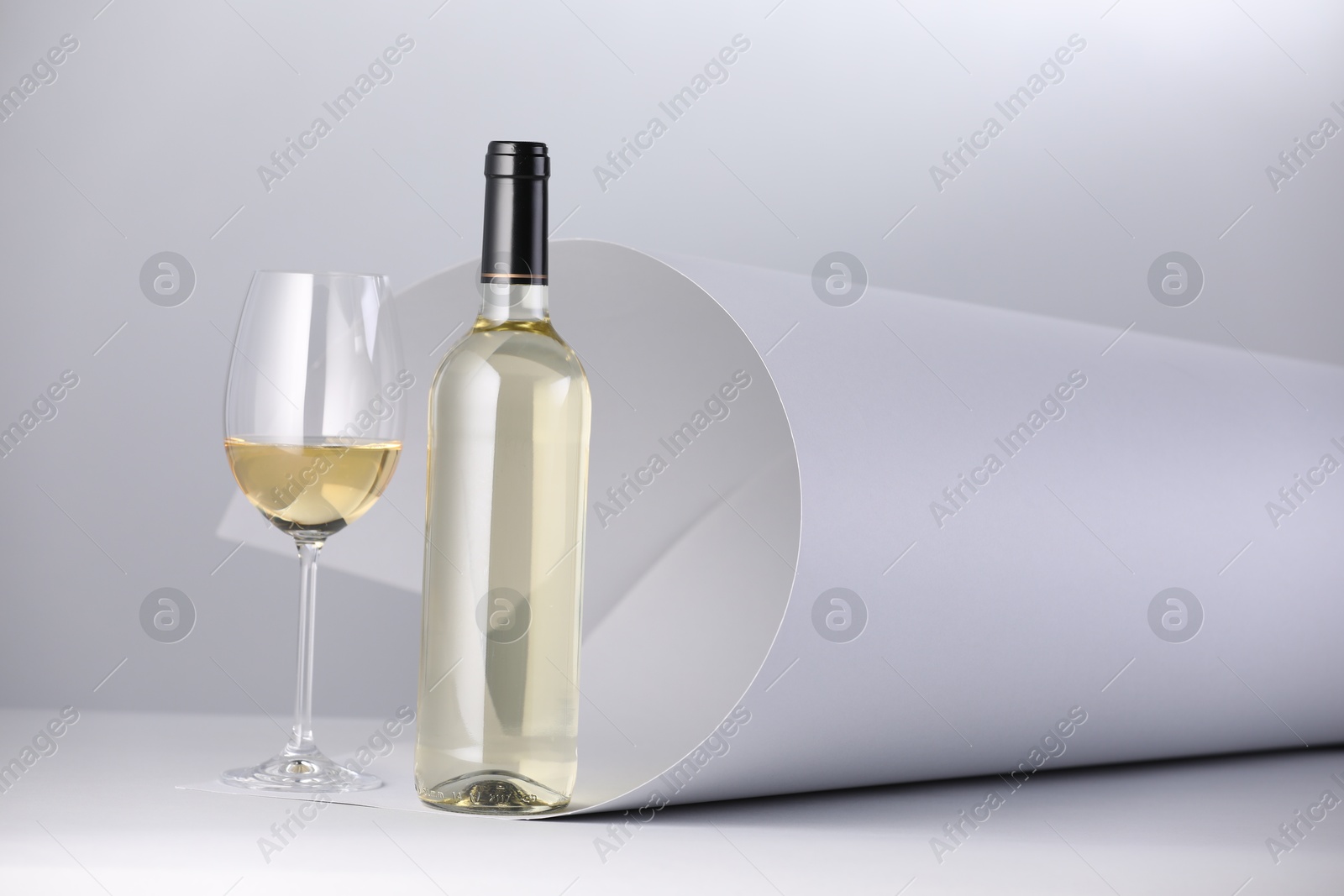 Bottle and glass of tasty wine on white background Photo of Bottle and glass of tasty wine on white background