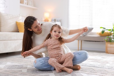 Photo of Happy mother having fun with her cute little daughter at home