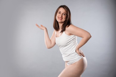 Photo of Woman in underwear on light grey background. Cellulite problem