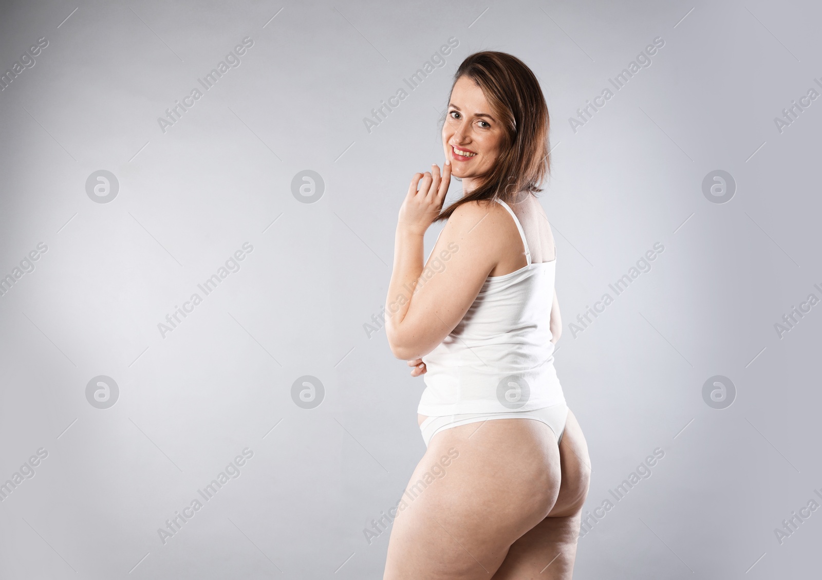 Photo of Woman in underwear on light grey background, space for text. Cellulite problem