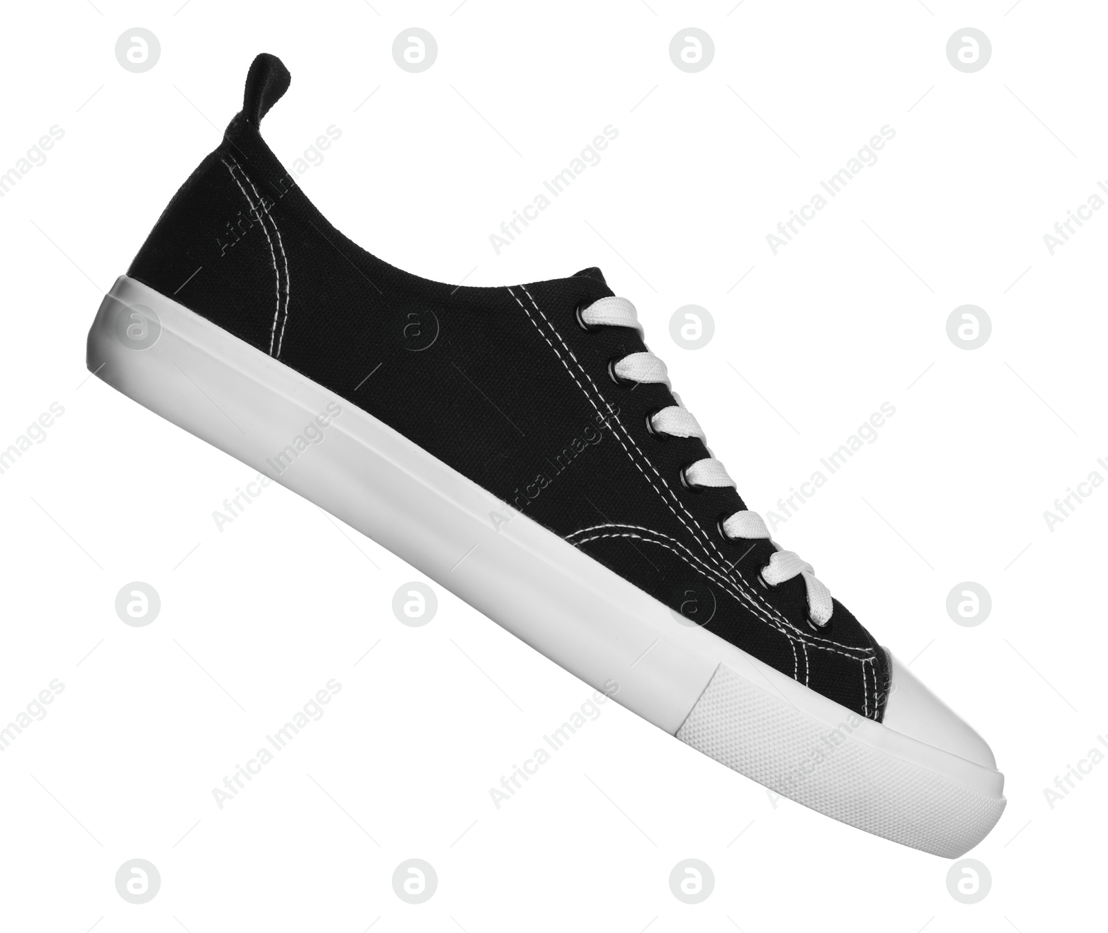 One black sneaker in air isolated on white Photo of One black sneaker in air isolated on white