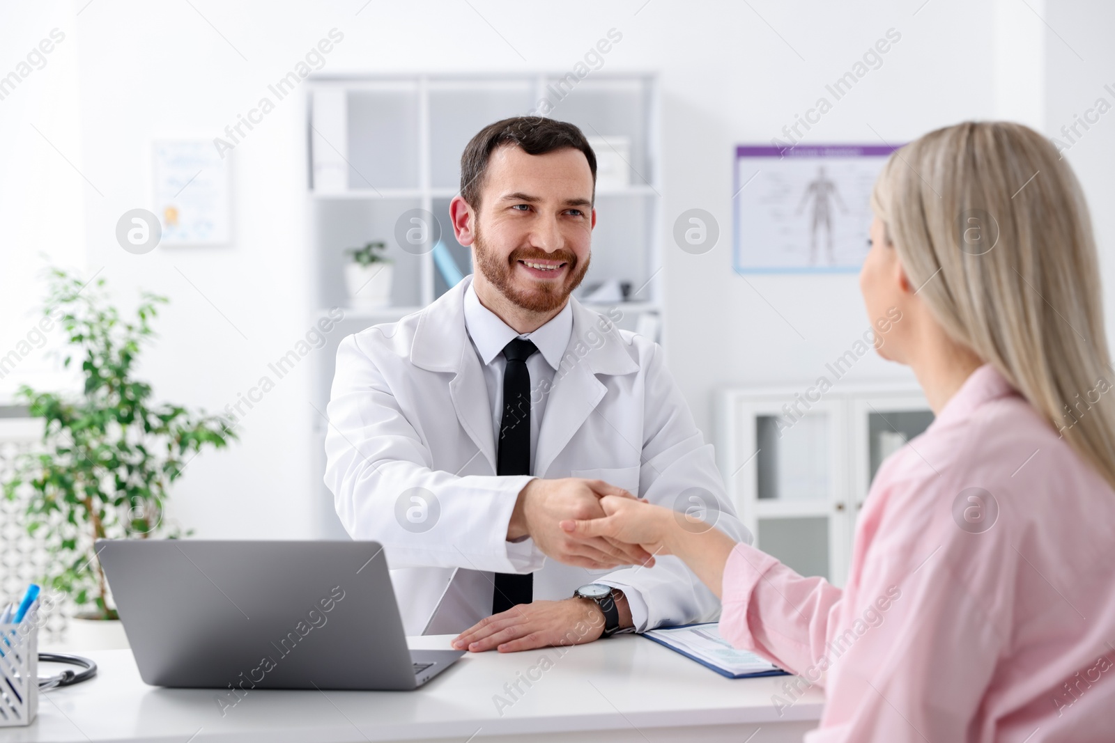 Photo of Doctor and patient shaking hands in hospital