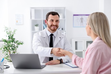 Photo of Doctor and patient shaking hands in hospital