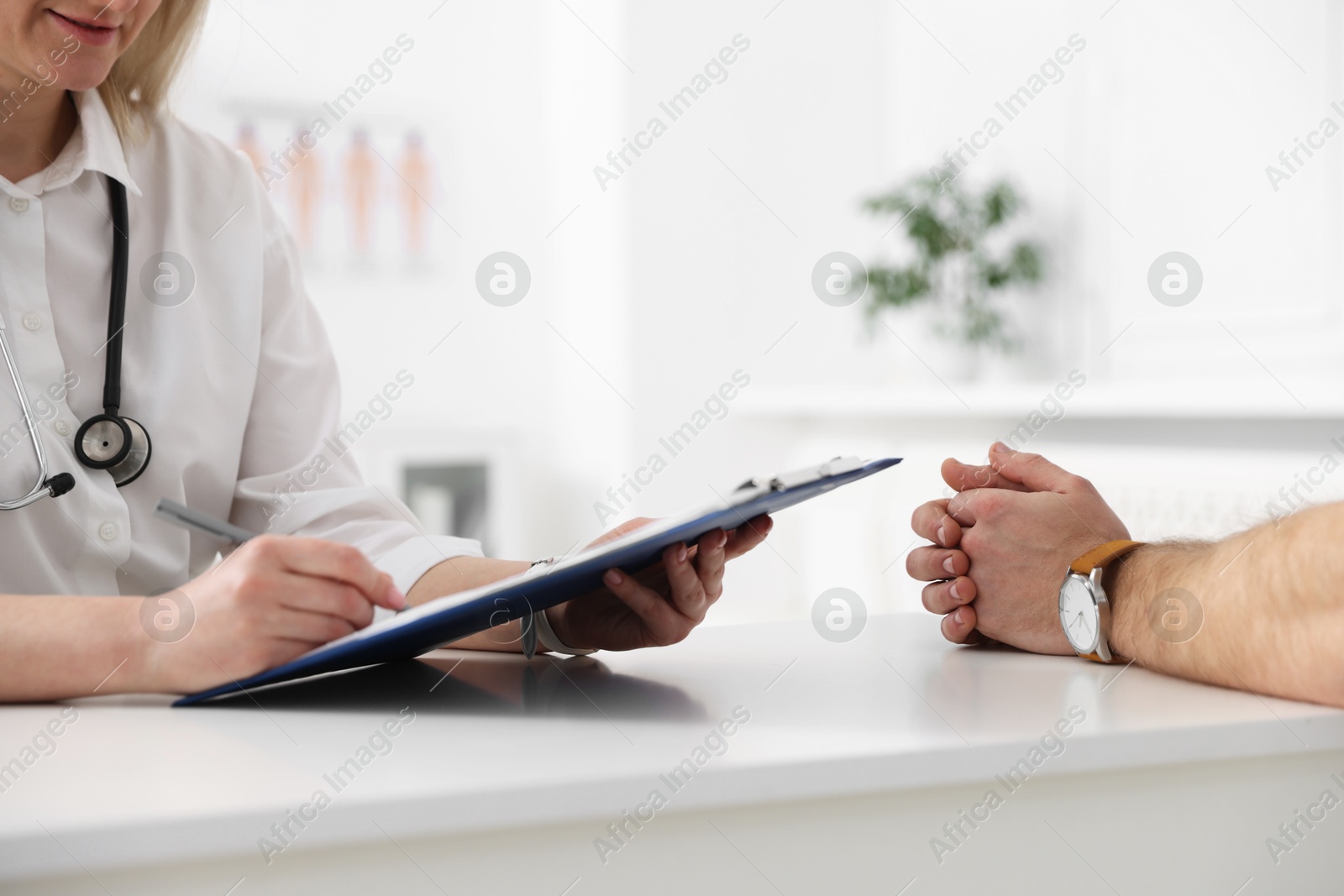 Photo of Man having appointment with doctor in hospital, closeup