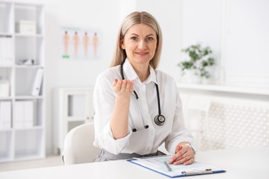 Professional doctor working at desk in hospital